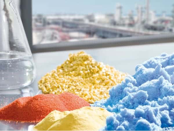 chemical substances on table top with industrial facility in window on background