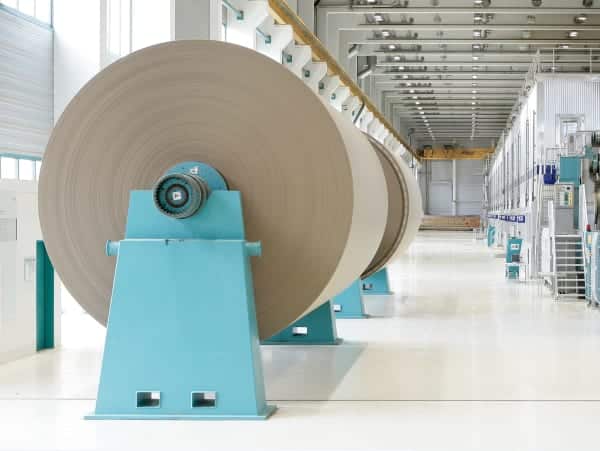 two paper reels in a paper mill from the side